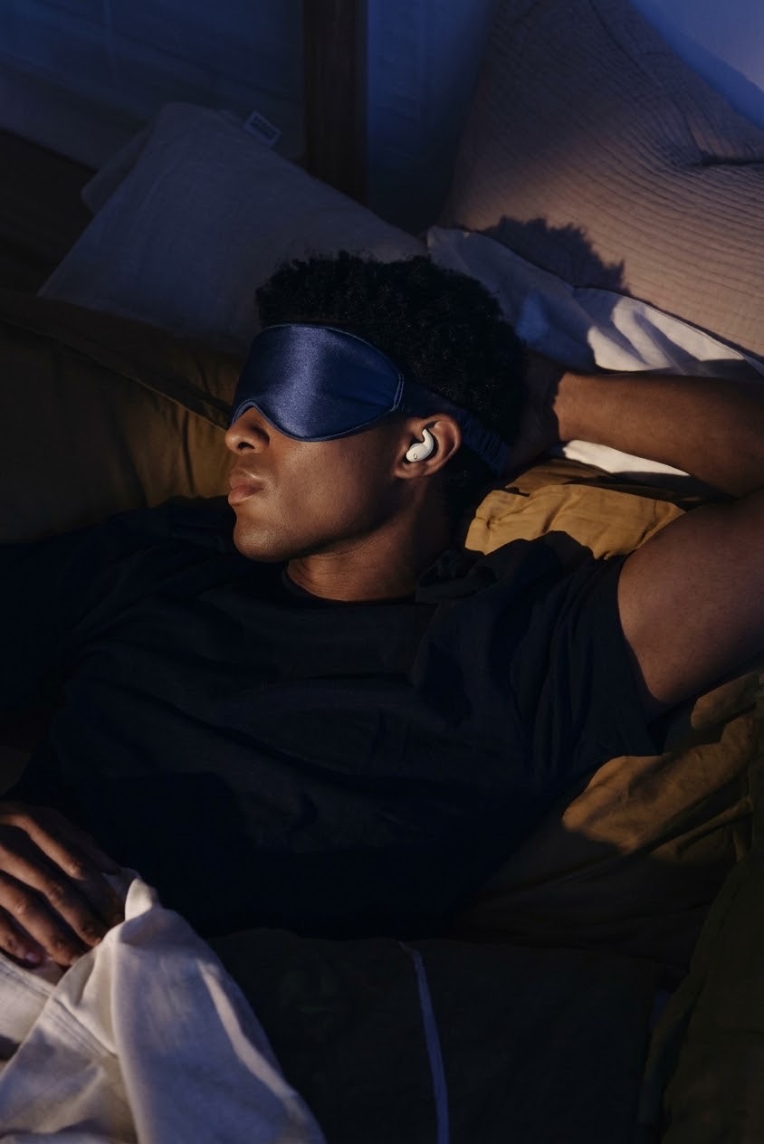 Model wearing The Void, the midnight navy blackout sleep mask